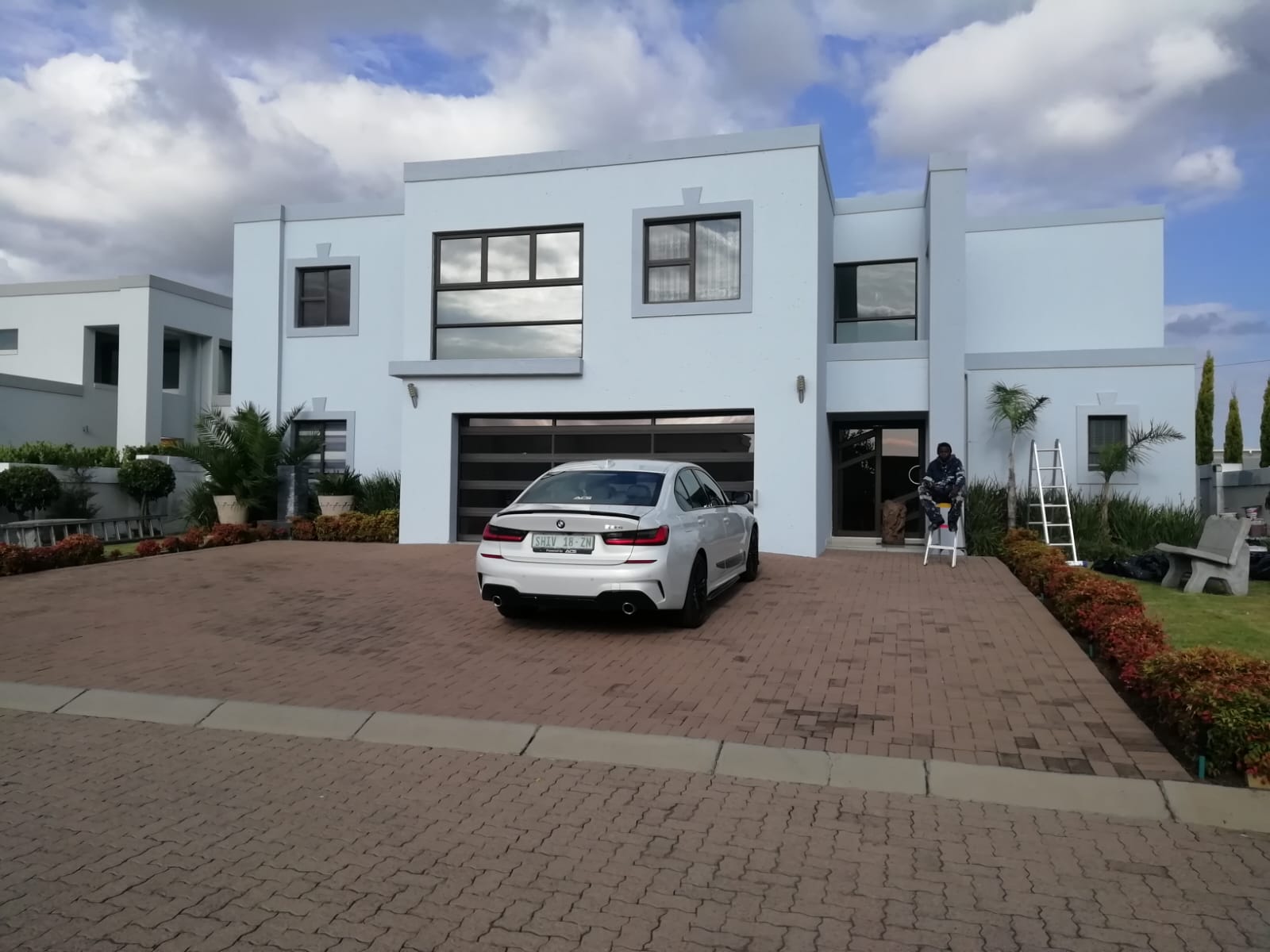 Double-storey home with newly painted exterior walls and paved driveway
