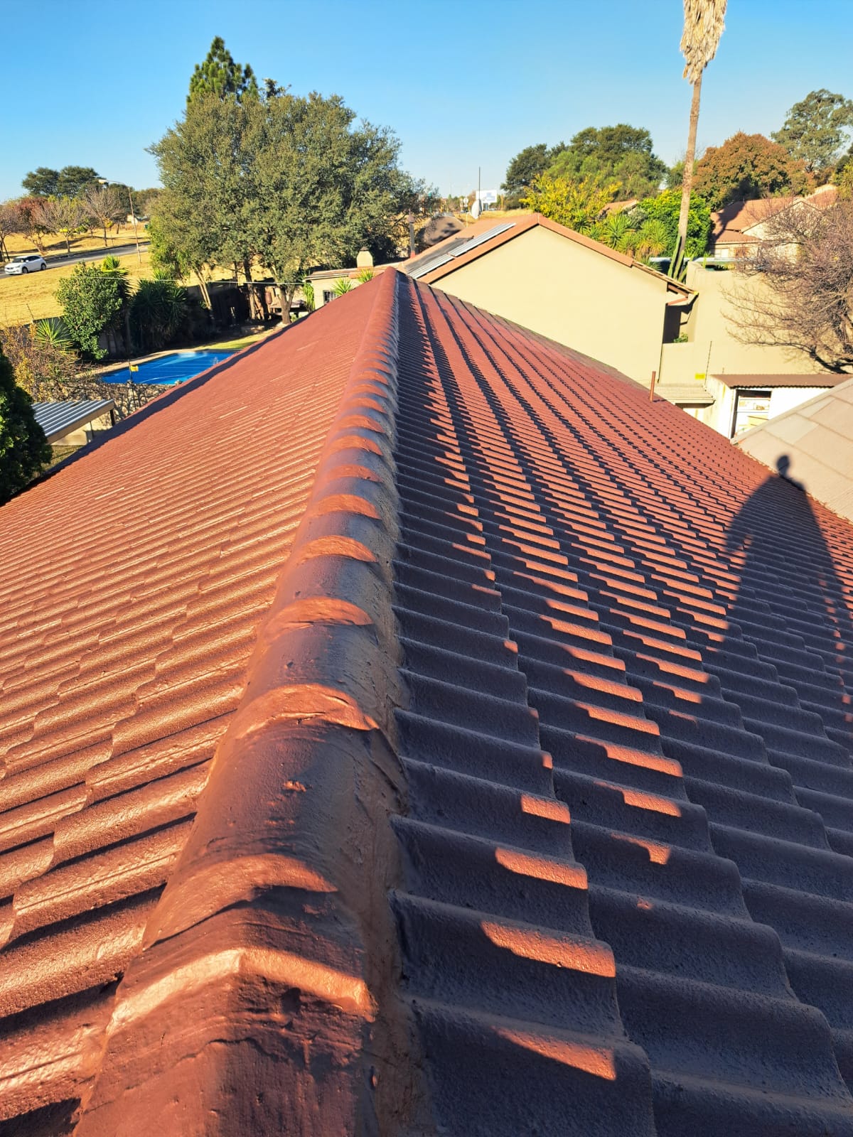 Roof sealing coating applied along the ridge of a residential tiled roof