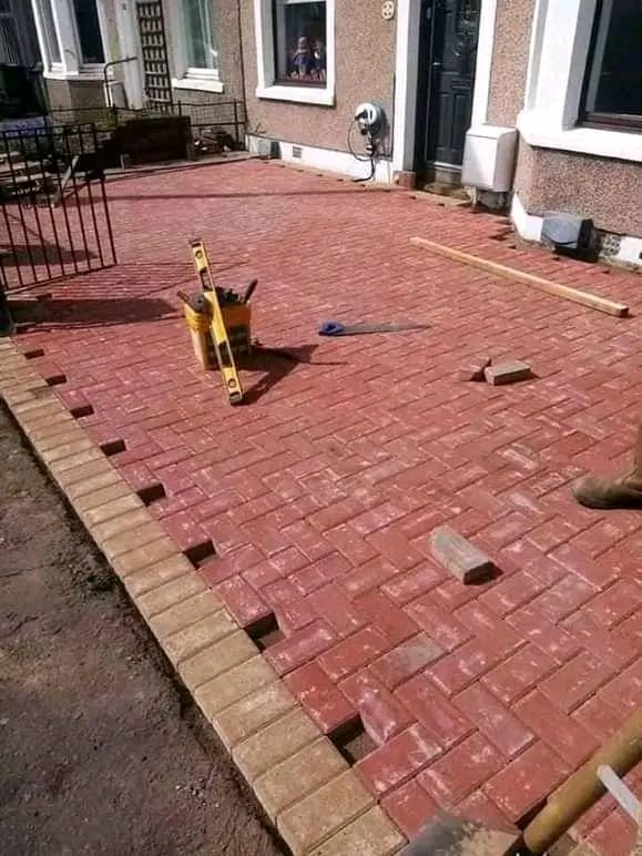 Red brick paving laid in a herringbone pattern in a residential courtyard