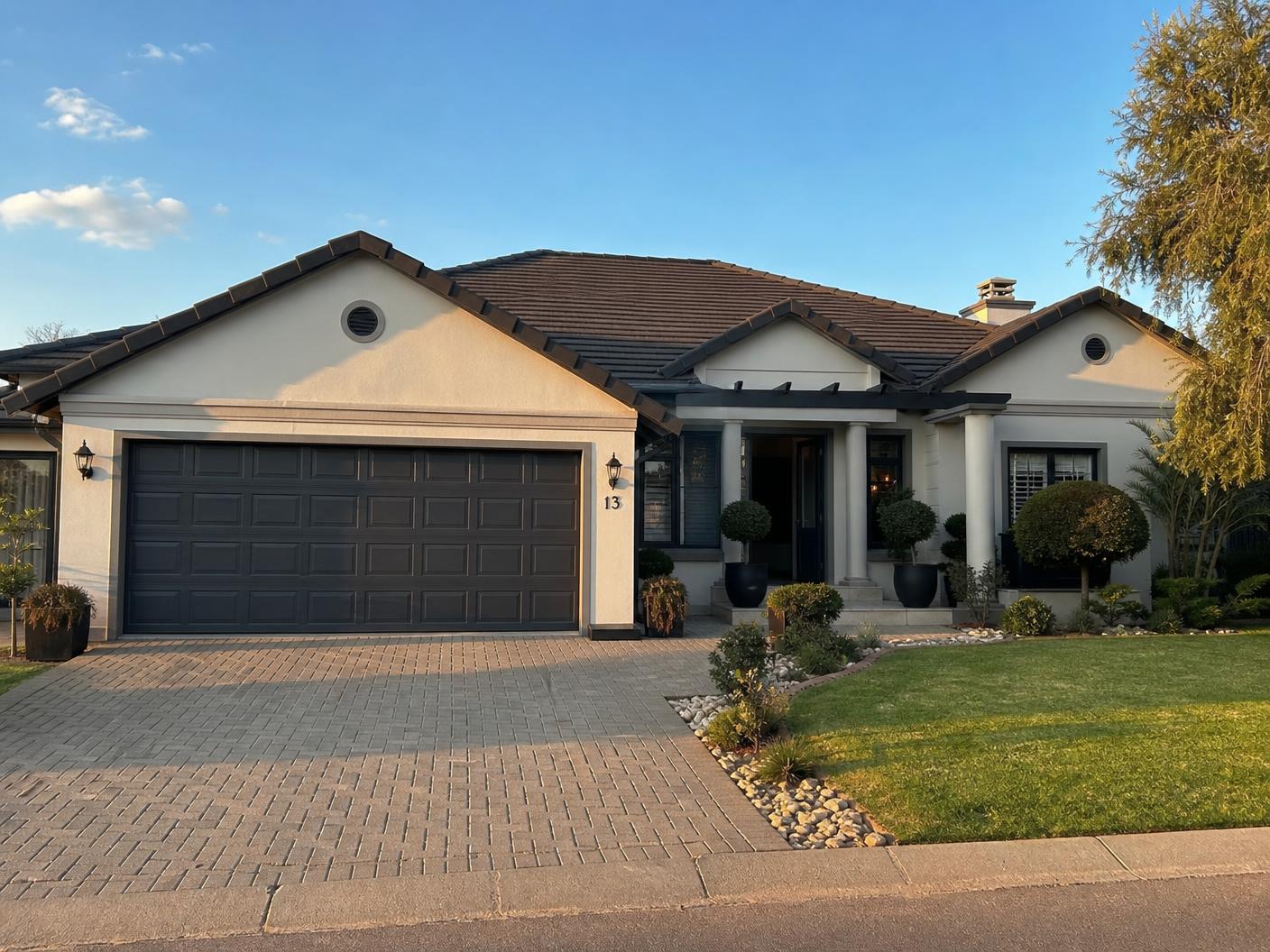Completed residential property with freshly painted exterior, paved driveway and neat roofline